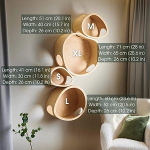 May include: A set of four wooden wall shelves in varying sizes (S, M, L, XL). The shelves are light brown and have a rounded, organic shape. Measurements are provided in inches and centimeters. The XL shelf is 28 inches long.