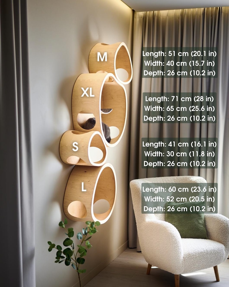 May include: A set of four wooden cat shelves in varying sizes (S, M, L, XL) mounted on a wall. Each shelf has a curved, oval shape with a light wood finish and a white interior. The dimensions are listed in inches and centimeters.