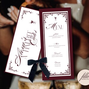 May include: Elegant wedding menu cards with a burgundy border and decorative corner accents. One card reads "Alexa's TIN BIT", the other displays a menu with appetizers, main courses, dessert, and drinks. A black velvet bow is attached.
