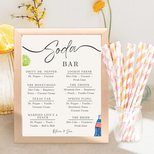 May include: A printable wedding sign with a white background and black text. The sign is titled "Soda Bar" and lists different soda combinations for a wedding reception. The sign includes the names "The Honeymoon", "Texas Tab", "Married Life's a Peach", "Lookin Fresh", "The Groom", "Spring Fling", and "The Bride".