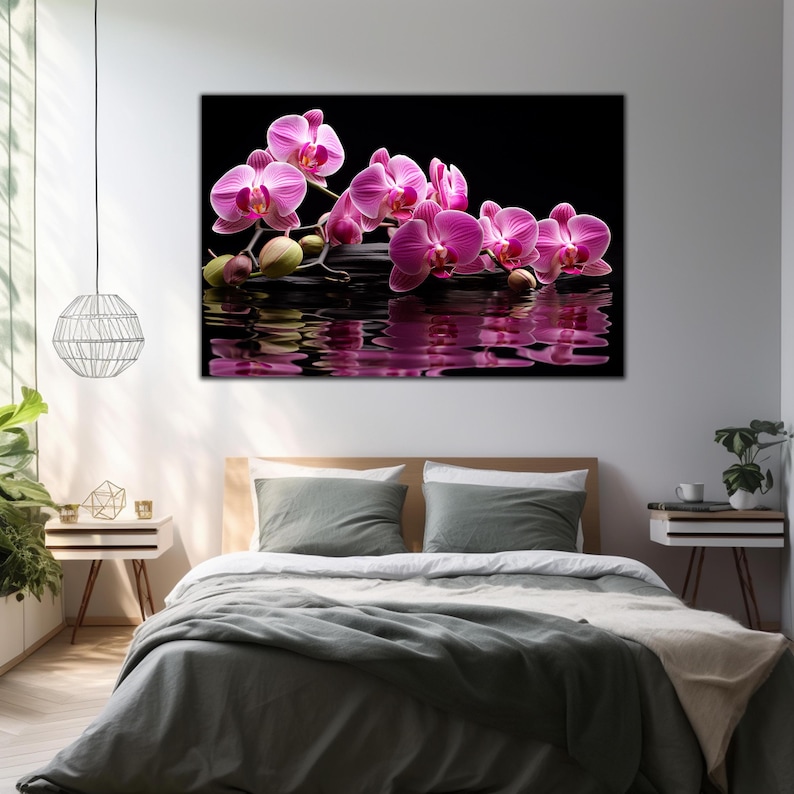 May include: Pink orchid flowers floating on a black reflective surface with smooth gray stones. The flowers are arranged in a line and their reflection is visible in the water.