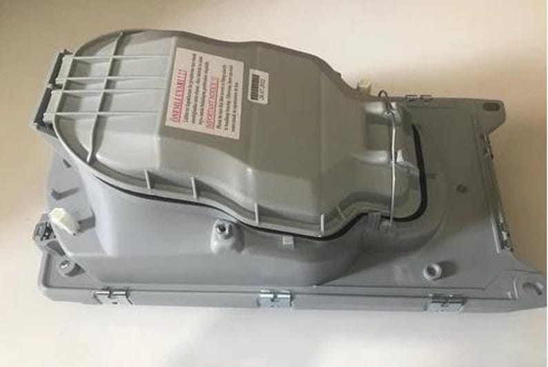 a gray plastic container with a warning label on it.