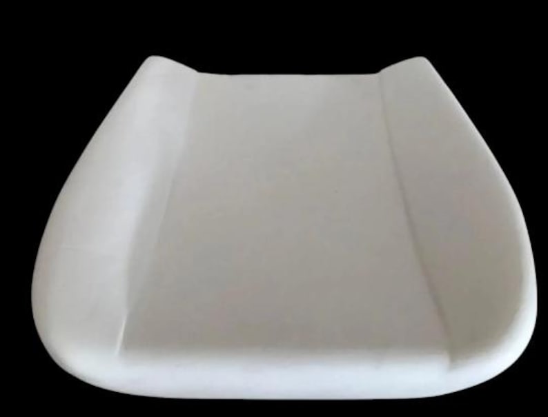 A white, rectangular object resembling a changing pad or pad for a baby.