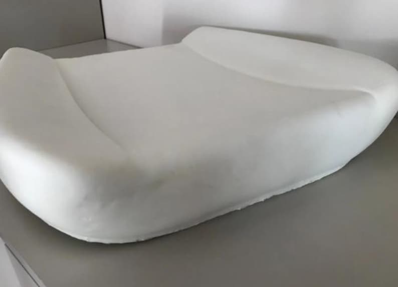 A white, rectangular object resembling a pillow or cushion is shown in the image.
