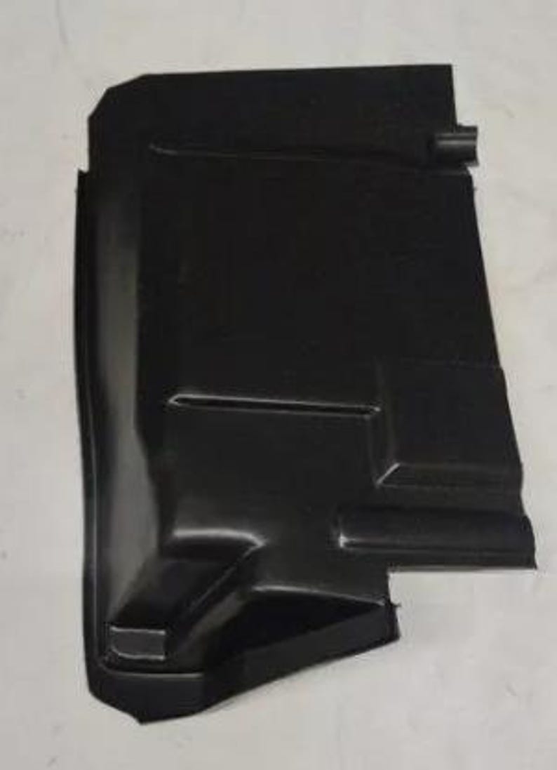 A black plastic object, possibly a part of a vehicle, is shown against a white background.