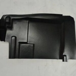 A black plastic car part, likely a trunk lid or cover, is shown against a white background.