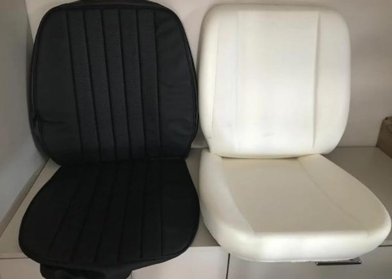 two car seat cushions, one black and one white, placed side by side.