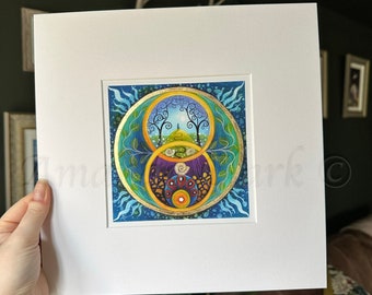 May include: A framed print of a colorful, abstract painting with a circular design. The painting features a blue background with gold accents and a central circle with a green, yellow, and purple design. The painting is surrounded by a white mat and a white frame.