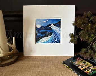 May include: A framed print of a watercolor painting depicting a woman with flowing white hair standing in a forest. The woman is reaching up towards a white bird flying overhead. The background is a dark blue sky with white stars. The painting is set against a white background.