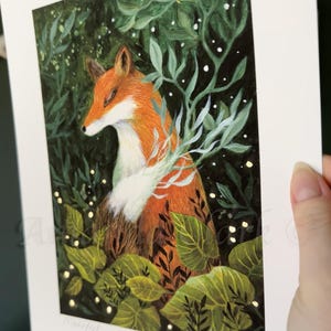 May include: A red fox with white fur on its chest is nestled in a lush green forest. The fox is surrounded by leaves and branches, and there are small white dots scattered throughout the image, resembling snow or stars.