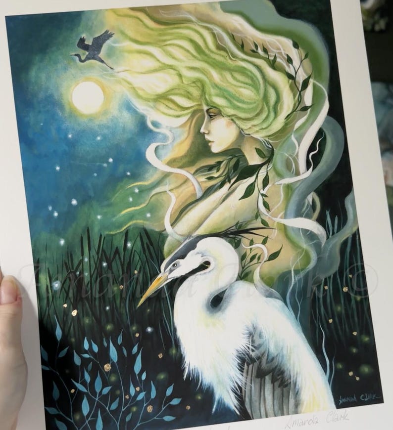 May include: A watercolor painting of a woman with flowing green hair and a white egret. The woman is surrounded by a blue and green background with a full moon and stars. The painting is signed "Miranda Clarke" in the bottom right corner.
