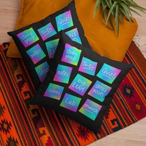 May include: Two black throw pillows with colorful sticky notes featuring words like "Quiz!", "Study Group", and "To-Do". The pillows rest on a patterned rug and a yellow cushion.