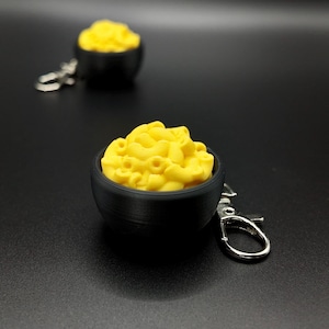 May include: A set of three ceramic mugs with a speckled, matte finish. Each mug features a different color: light blue, cream, and gray. The mugs have a simple, modern design and a comfortable handle.