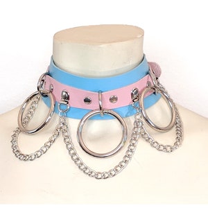 May include: A light blue and pink leather choker with silver metal rings and chains.