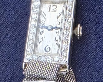 E. Huguenin 18K/platina en diamanten horloge