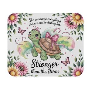 May include: A square mousepad with a cartoon turtle wearing a pink bow, set amongst flowers and butterflies. The text reads "She overcame everything that was sent to destroy her" and "Stronger than the storm."