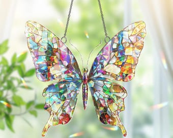 May include: A colorful stained glass butterfly suncatcher with a mosaic design. The butterfly has a detailed body and antenna, and is suspended by a chain. The wings feature a variety of colors including blue, green, yellow, and red.