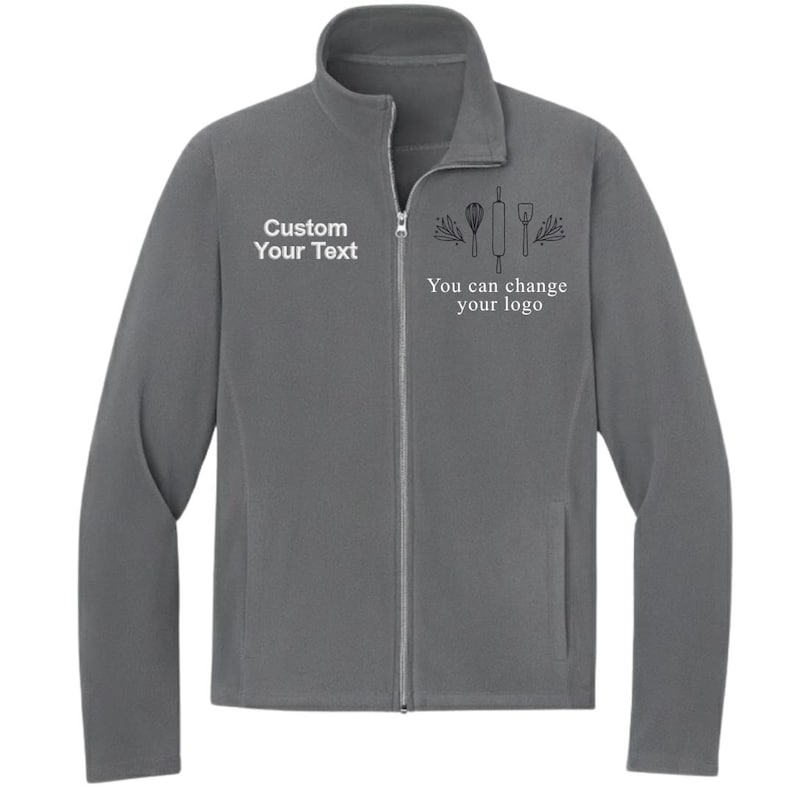 May include: A gray fleece jacket with a full zipper and a stand-up collar. The jacket has the text "Custom Your Text" on the left chest and "You can change your logo" with baking-themed graphics on the right chest.