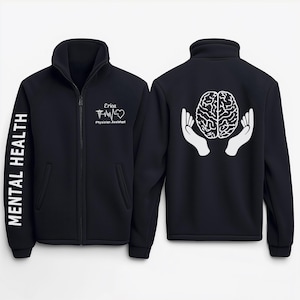 May include: Black fleece zip-up jacket with a white brain graphic on the back and the text "Mental Health" on the left sleeve. The front of the jacket has the text "Erica Physician Assistant" and a heart with a heartbeat graphic.