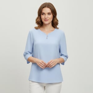 May include: A light blue blouse with three-quarter sleeves and a notched neckline. The top has a simple, elegant design and a subtle keyhole detail at the neckline. The blouse is paired with white pants.