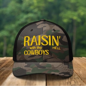 Embroidered Raisin Hell With The Cowboys Camo Hat, raisin hell hat, raisin hell trucker hat, cowboy hat, rodeo hat, cowgirl hat, western hat