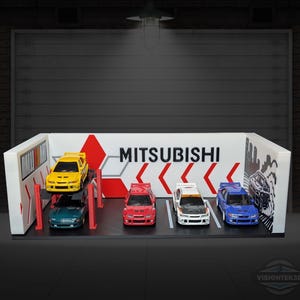 May include: A diorama featuring miniature Mitsubishi model cars in various colors, including yellow, green, red, white, and blue. The backdrop displays the Mitsubishi logo and a garage scene, with a red and white design.