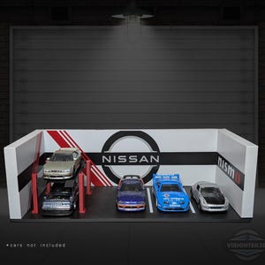 May include: A white and red display stand with the Nissan logo and the word "nismo" in red. The stand features a black base with several model cars. The text "cars not included" is at the bottom.