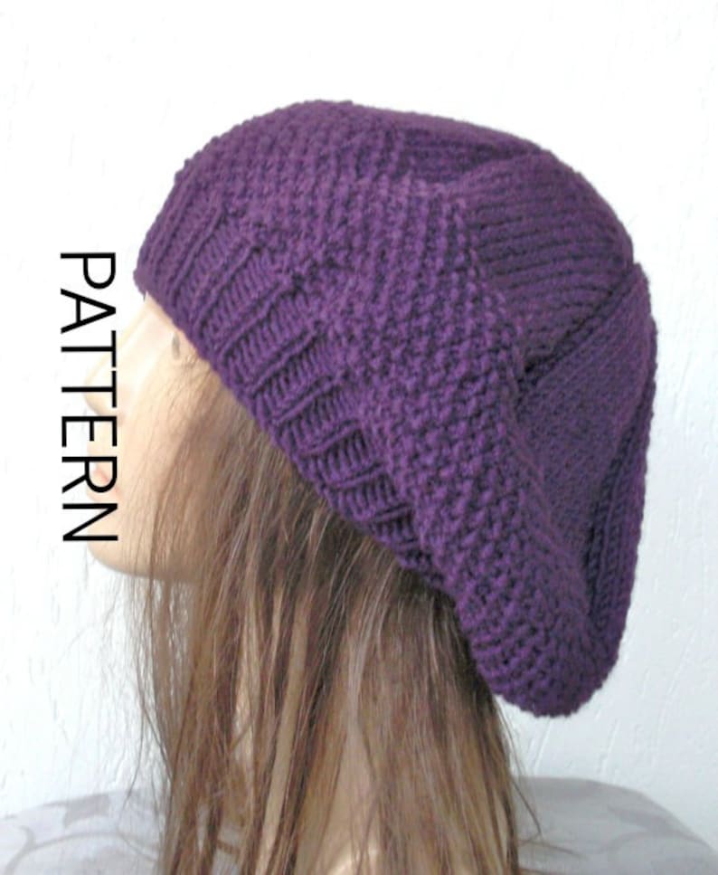 May include: A purple knitted beanie with a slouchy fit. The beanie is made with a textured stitch pattern.