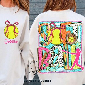 May include: A white sweatshirt with a pink and yellow softball design. The design includes the words "Softball" and a player with a bat. The sweatshirt also has a pink bow and the name "Jessie" on the front.