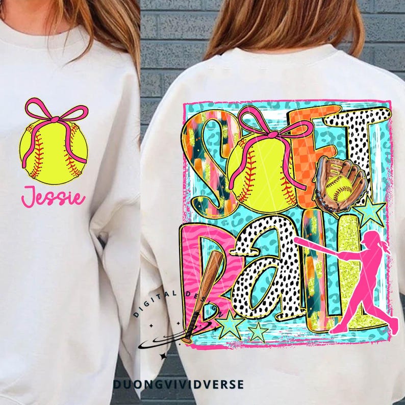 May include: A white sweatshirt with a pink and yellow softball design. The design includes the words "Softball" and a player with a bat. The sweatshirt also has a pink bow and the name "Jessie" on the front.