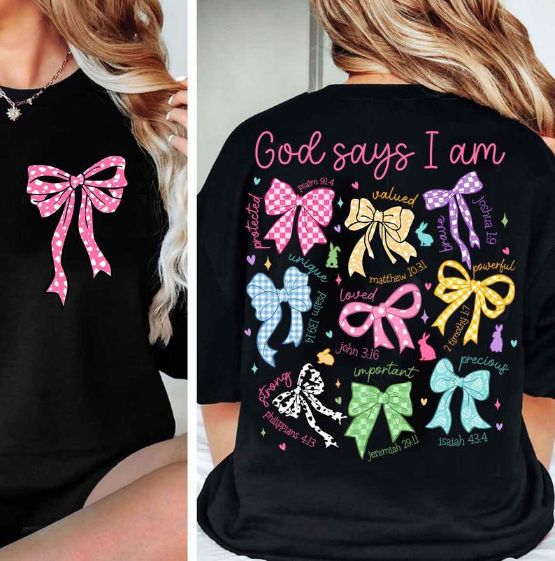 May include: Black t-shirt with a colorful bow design and the text "God says I am" with bible verses and words like "protected", "unique", "loved", "valued", "brave", "powerful", "strong", "important", and "precious".