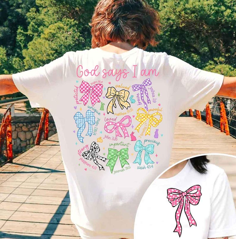 May include: White t-shirt with the text "God says I am" and a circle of colorful bows with bible verses. Each bow has a word describing a quality, such as "strong", "unique", "loved", "important", "precious", "valued", "protected", "peaceful", "joyful".