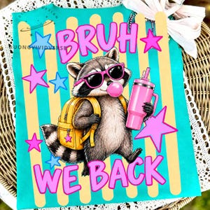 May include: A teal t-shirt featuring a raccoon wearing pink sunglasses and a yellow backpack, holding a pink tumbler, and blowing a pink bubble. The text reads BRUH WE BACK, surrounded by pink and blue stars on a background of vertical yellow stripes.