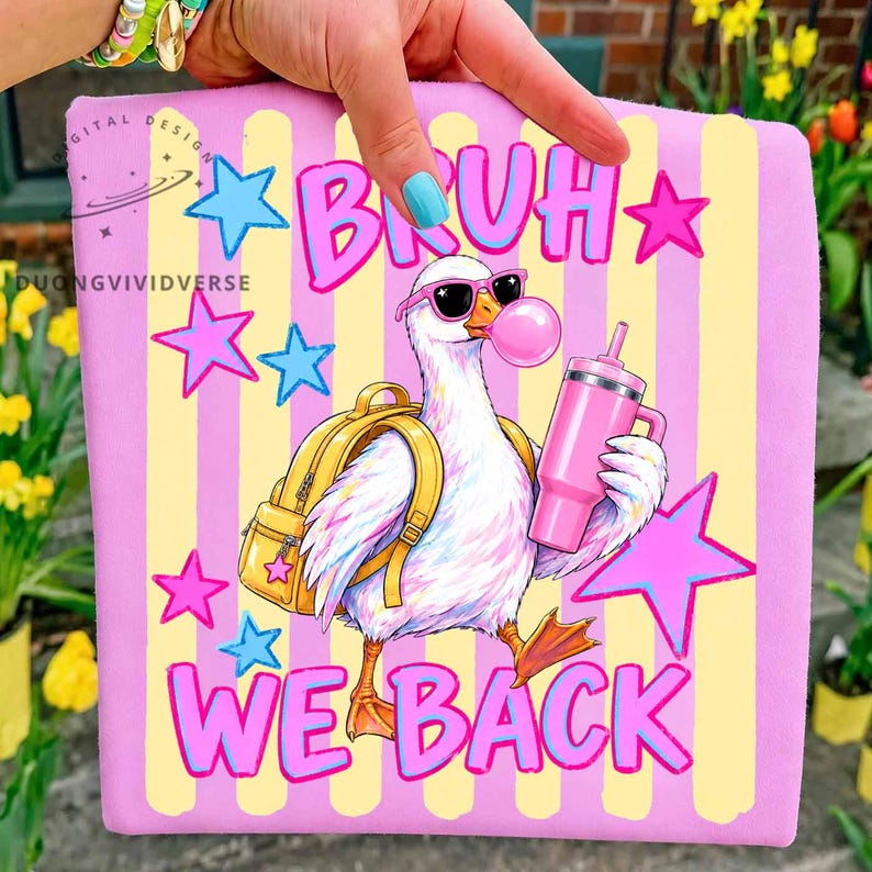 May include: A light purple fabric square featuring a yellow-striped background and a graphic of a white duck wearing pink sunglasses and a yellow backpack. The duck holds a pink tumbler and blows a bubble. The text reads BRUH WE BACK in pink.