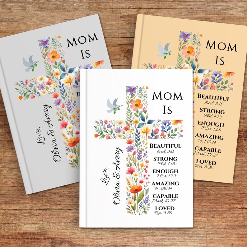 May include: Three hardcover journals with floral cross designs. The journals are in white, light gray, and tan. Each journal has the words "MOM IS" and inspirational words. The journals are personalized with the names "Olivia & Avery".