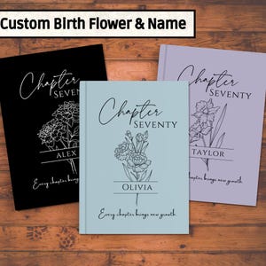 May include: Three personalized notebooks with floral designs. The notebooks are in black, light blue, and lavender. Each notebook features the text "Chapter Seventy" and a name, with the phrase "Every chapter brings new growth."