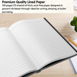 May include: Open notebook with lined pages. The text at the top reads "Premium Quality Lined Paper". The notebook has 150 pages of thick, acid-free paper designed to prevent ink bleed-through.