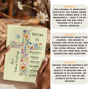 May include: A journal with a floral cross design and the words "Mom Is" on the cover. The cross is filled with colorful flowers and leaves. The journal also includes the words "Beautiful," "Strong," "Enough," "Amazing," "Capable," and "Loved."