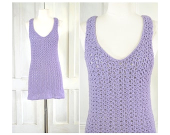 May include: A lavender crochet tank top with a V-neck and a delicate open stitch pattern.