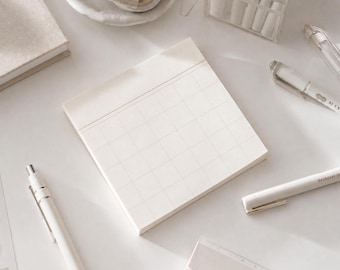 May include: A square off-white sticky note pad featuring a grid pattern and a horizontal line near the top edge. The paper is matte and light-colored, designed for writing or organizing notes, and is presented as a single stack of individual sheets.