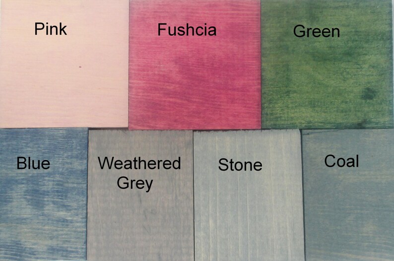 May include: A set of eight wood samples stained in different colors, including pink, fuschia, green, blue, weathered grey, stone, and coal.