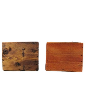May include: Two wooden squares, one stained a dark brown and the other a light orange-brown.