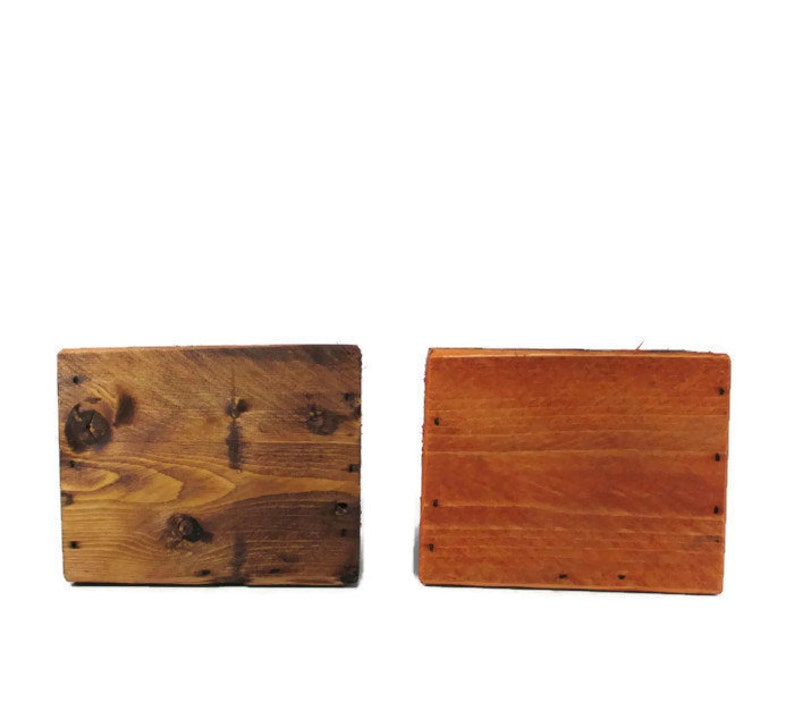May include: Two wooden squares, one stained a dark brown and the other a light orange-brown.