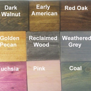 May include: A wood stain color chart with 15 different wood stain colors. The colors are arranged in three rows of five. The colors are: Ebony, Dark Walnut, Early American, Red Oak, Gunstock, Colonial Maple, Golden Pecan, Reclaimed Wood, Weathered Grey, Stone, Blue, Fuchsia, Pink, Coal, and Green.