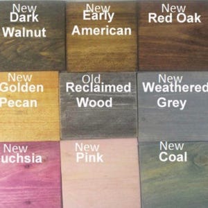 May include: A color chart showing 15 different wood stain colors. The colors are arranged in three rows of five. The colors are: New Ebony, New Dark Walnut, New Early American, New Red Oak, New Gunstock, New Colonial Maple, New Golden Pecan, Old Reclaimed Wood, New Weathered Grey, New Stone, New Blue, New Fuchsia, New Pink, New Coal, New Green.