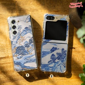 May include: Two clear phone cases with a blue and white Japanese-inspired design. The case on the left is for a standard phone, while the case on the right is for a foldable phone.