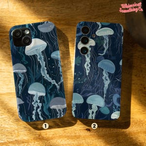 May include: Two phone cases with a blue background and white jellyfish designs. The cases are labeled 1 and 2.