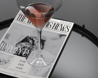 Może przedstawiać: Martini z różowym napojem stoi na gazecie z ogłoszeniem ślubnym z nagłówkiem "Happily Ever After" i datą "June 19th 2026".