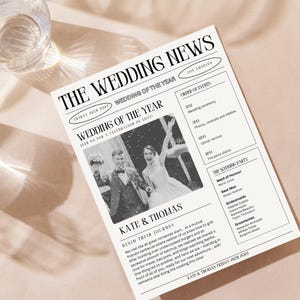 May include: A black and white newspaper style wedding announcement with a photo of the couple. The headline reads "The Wedding News" and the subheading reads "Wedding of the Year". The announcement includes the couple's names, Kate & Thomas, and the date of the wedding, Friday 26th 2027. The announcement also includes a list of the wedding party members.