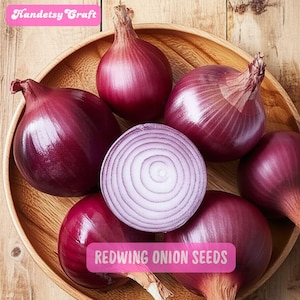 May include: A wooden bowl filled with Redwing onion seeds. The bowl contains several whole red onions and one sliced in half, revealing concentric rings. The text "Handetsy Craft" and "REDWING ONION SEEDS" are visible.